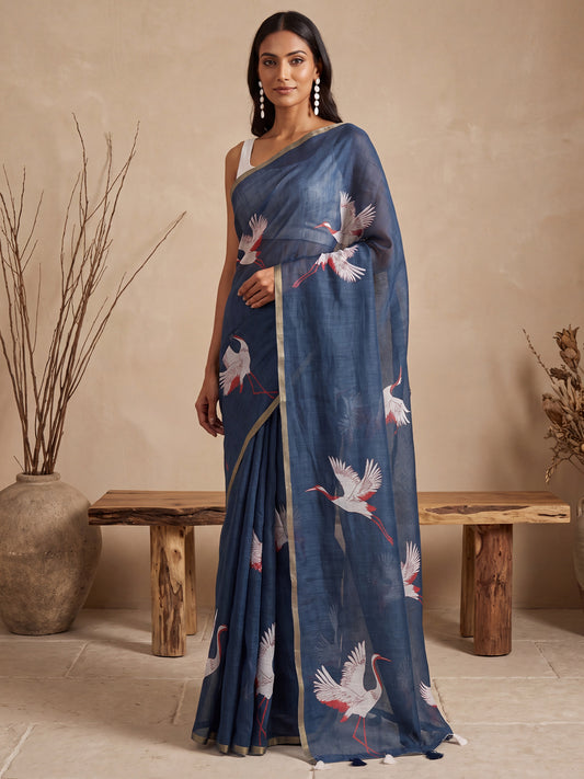 Woman wearing navy blue cotton linen saree with traditional indian motif work and white blouse