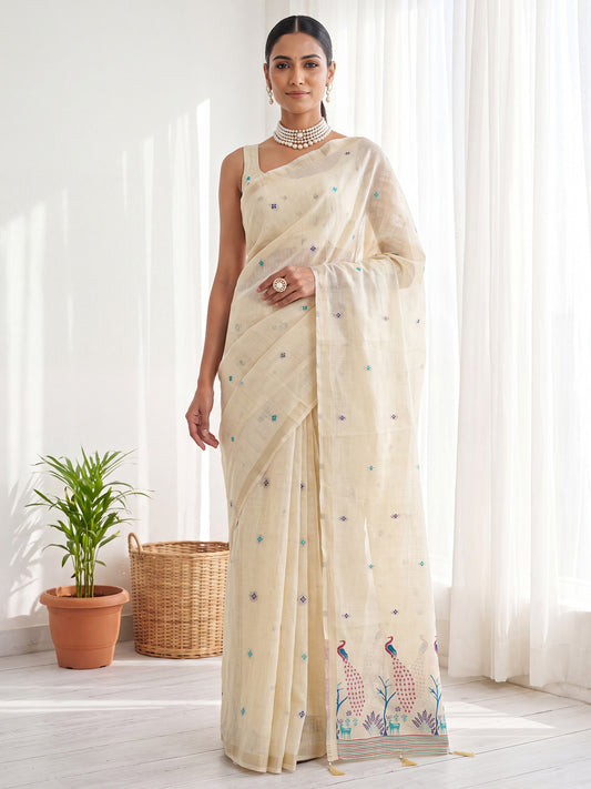 Woman wearing cream cotton linen saree with peacock motif design and cream blouse