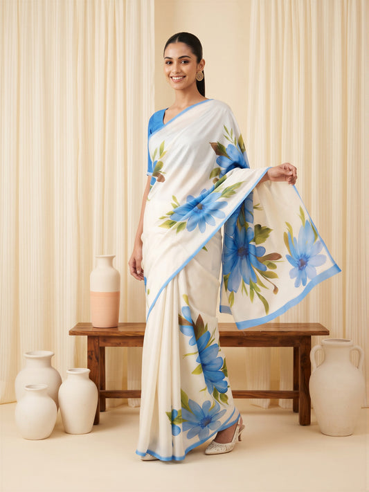 Woman wearing light blue chiffon saree with all-over floral design and light blue blouse