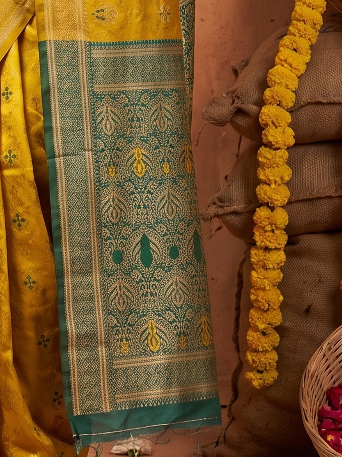 Pallu detail of mustard silk blend saree showing traditional indian motif work and zari border