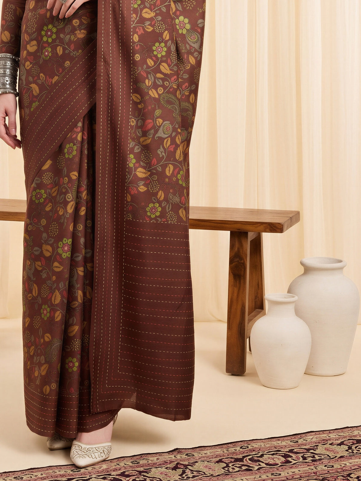 Pallu detail of brown silk blend saree showing kalamkari narrative motif work and embellished border