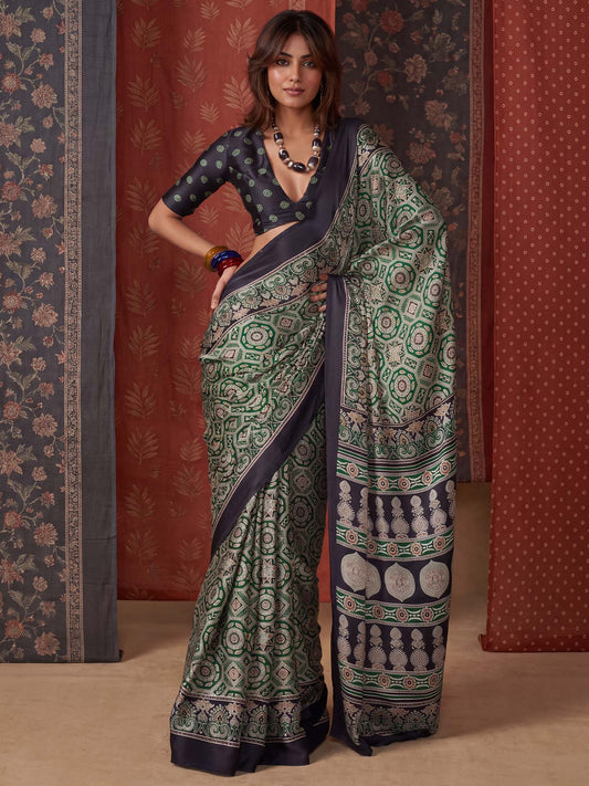 Woman wearing green crepe saree with ajrak block-print motif work and black blouse