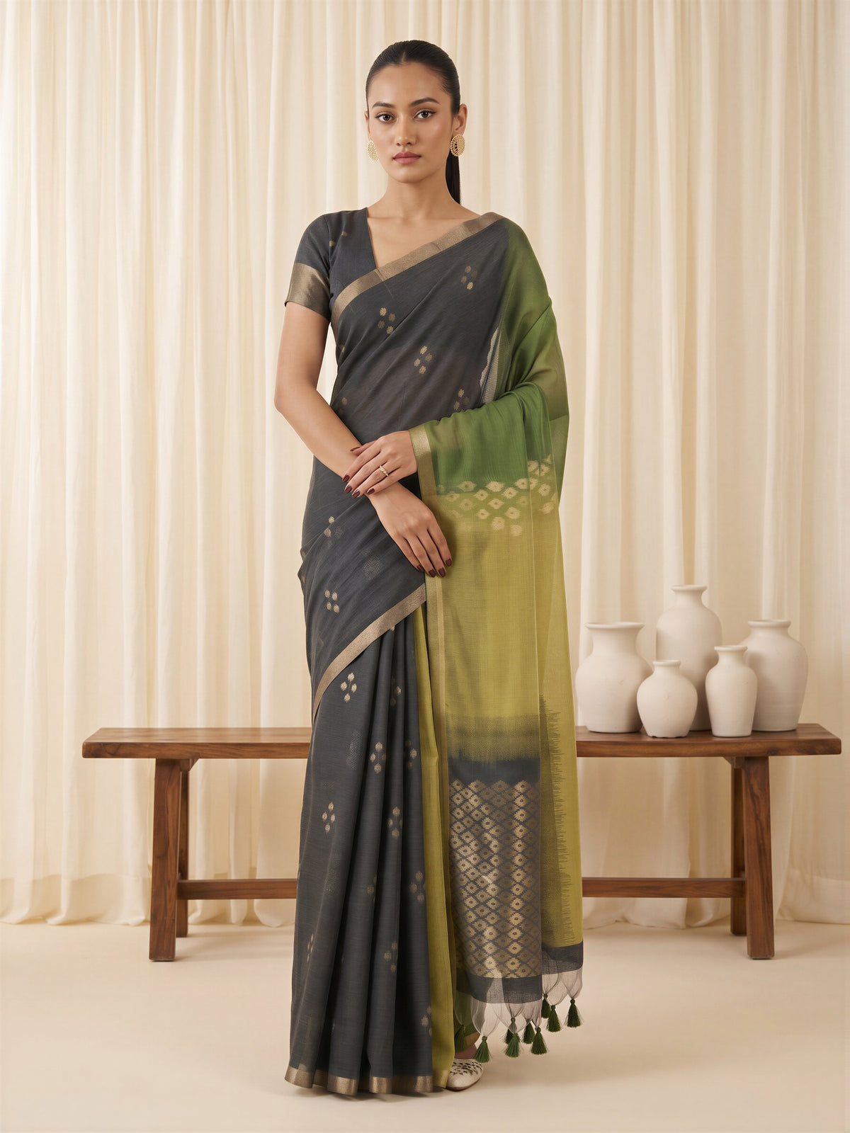 Woman wearing green viscose silk saree with traditional indian motif work and black blouse
