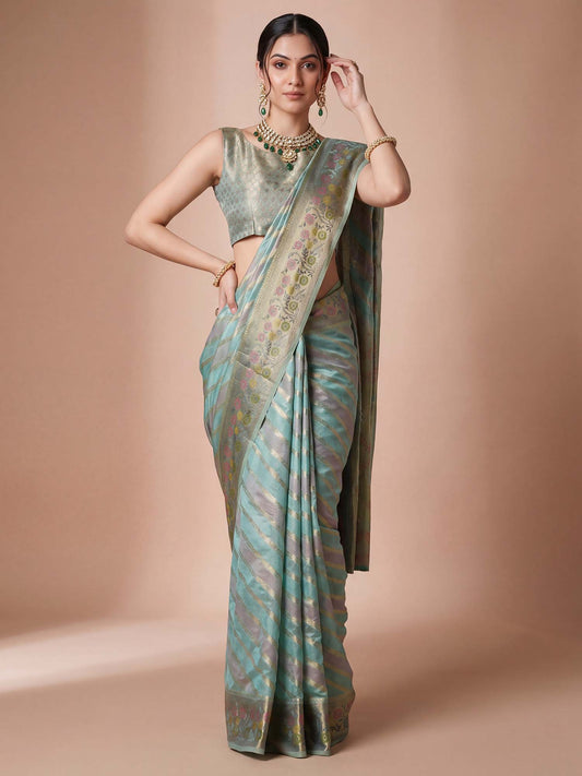 Woman wearing light blue organza saree with striped pattern design and light blue blouse