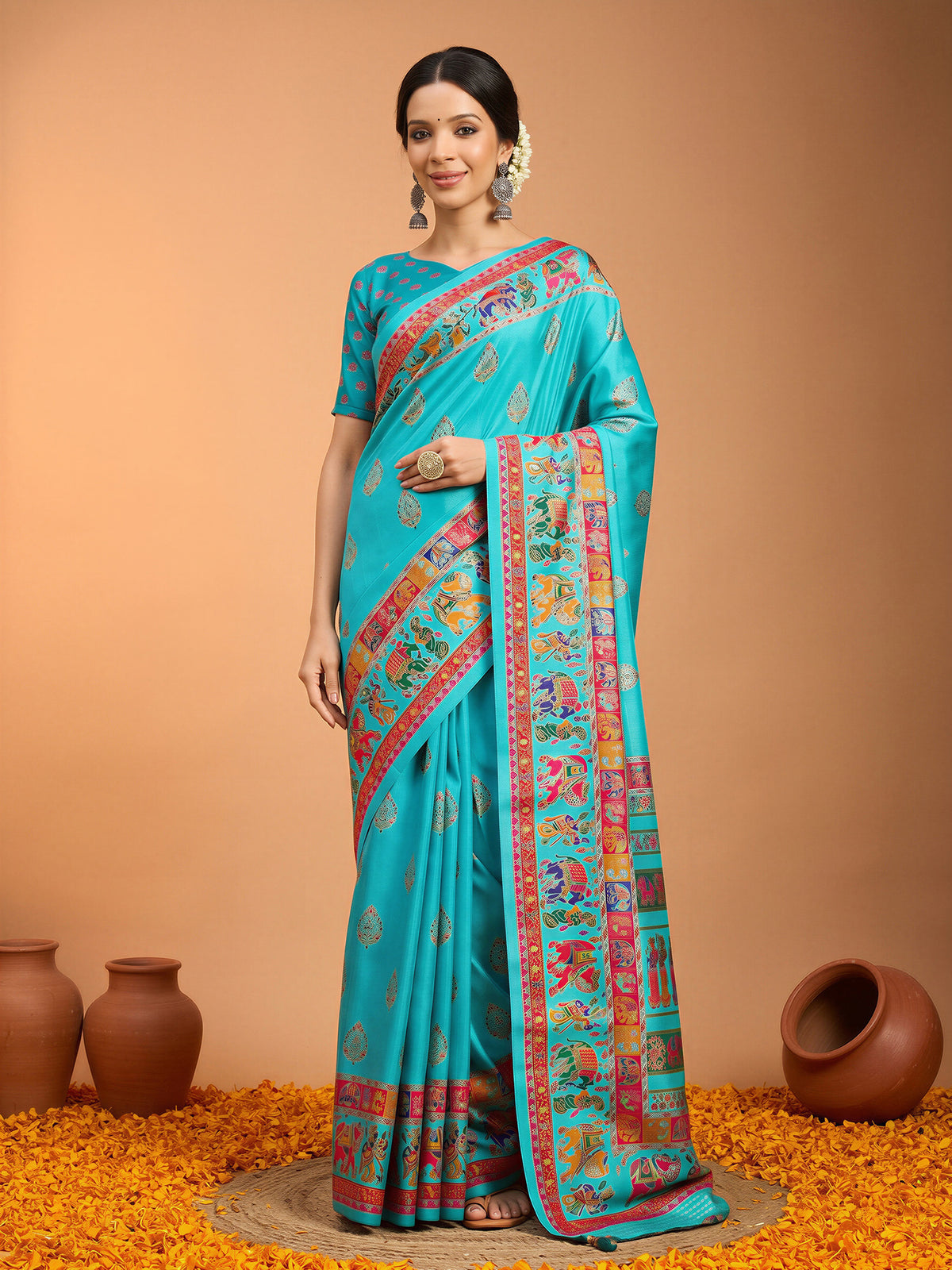 Woman wearing teal blue silk blend saree with metallic foil print work and teal blue blouse