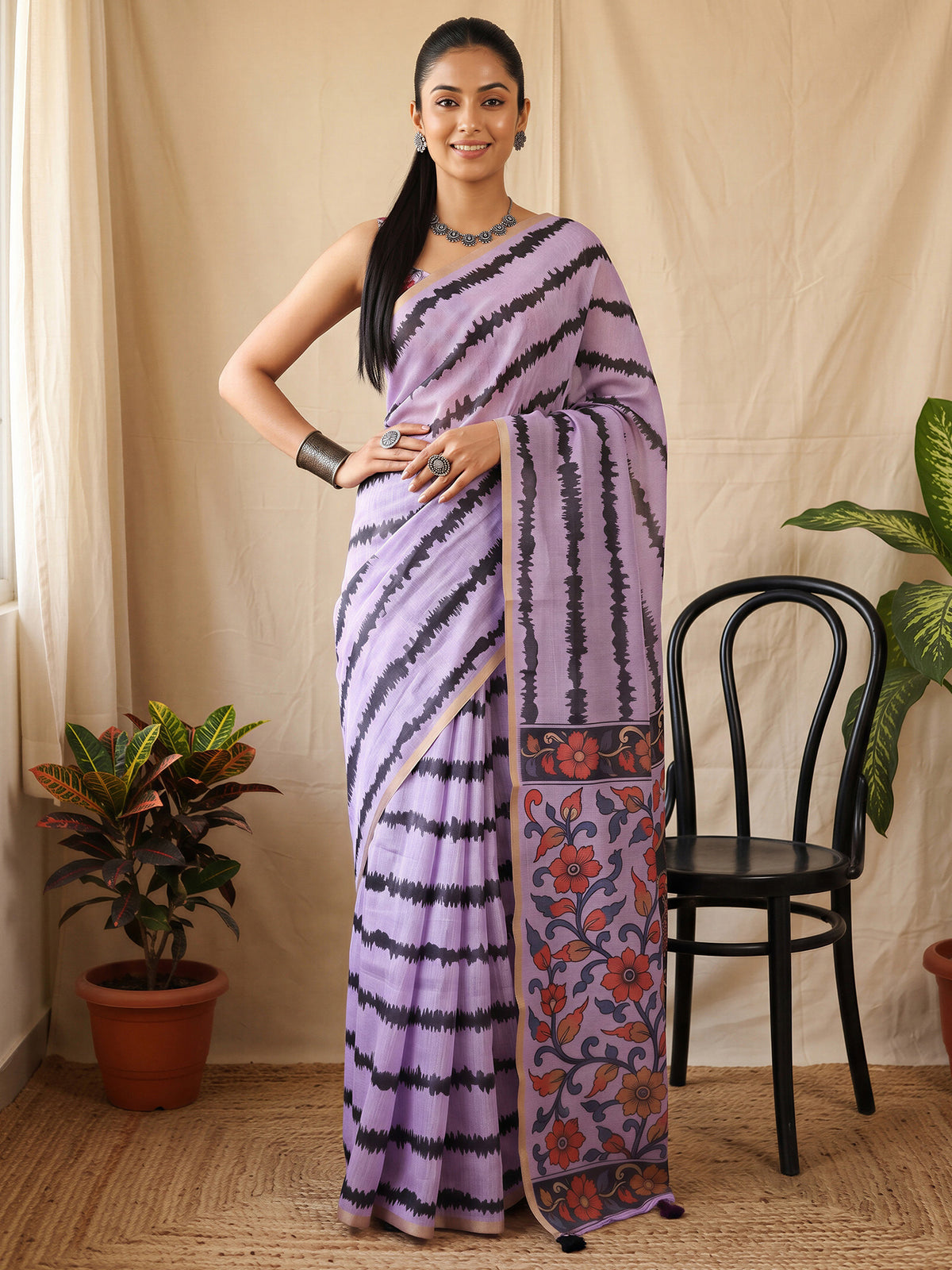 Woman wearing lavender cotton blend saree with kalamkari narrative motif work and lavender blouse