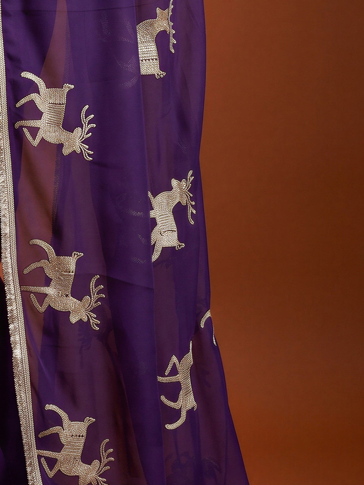 Pallu detail of purple georgette saree showing embroidered motif work and embellished border