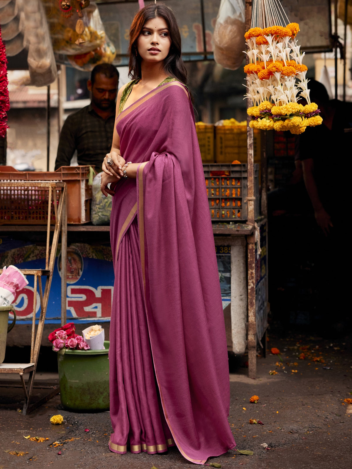 Woman wearing mauve cotton blend saree with clean solid-tone finish and olive blouse