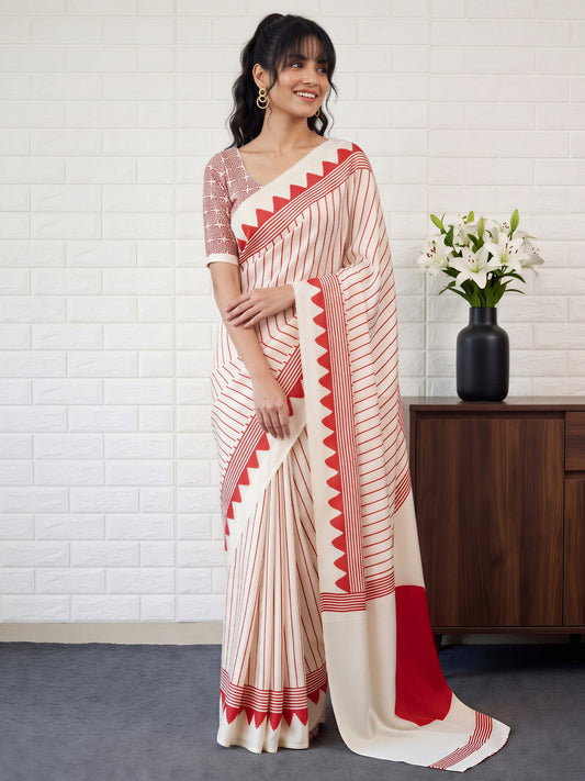 Woman wearing cream satin saree with striped pattern design and cream blouse