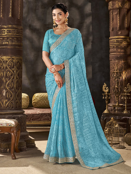 Woman wearing turquoise blue chiffon saree with bandhani tie-dye dot work and turquoise blue blouse