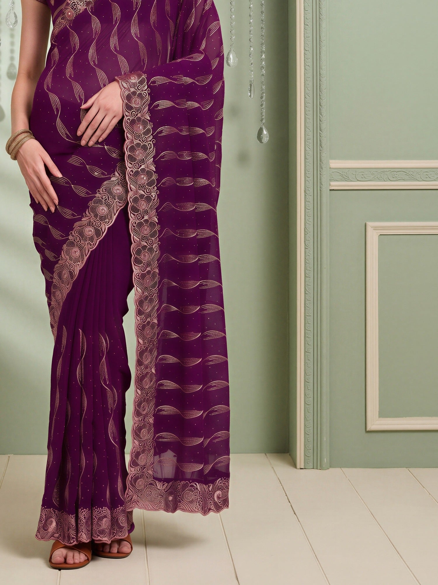 Pallu detail of purple pure georgette saree showing geometric pattern design and embroidered border