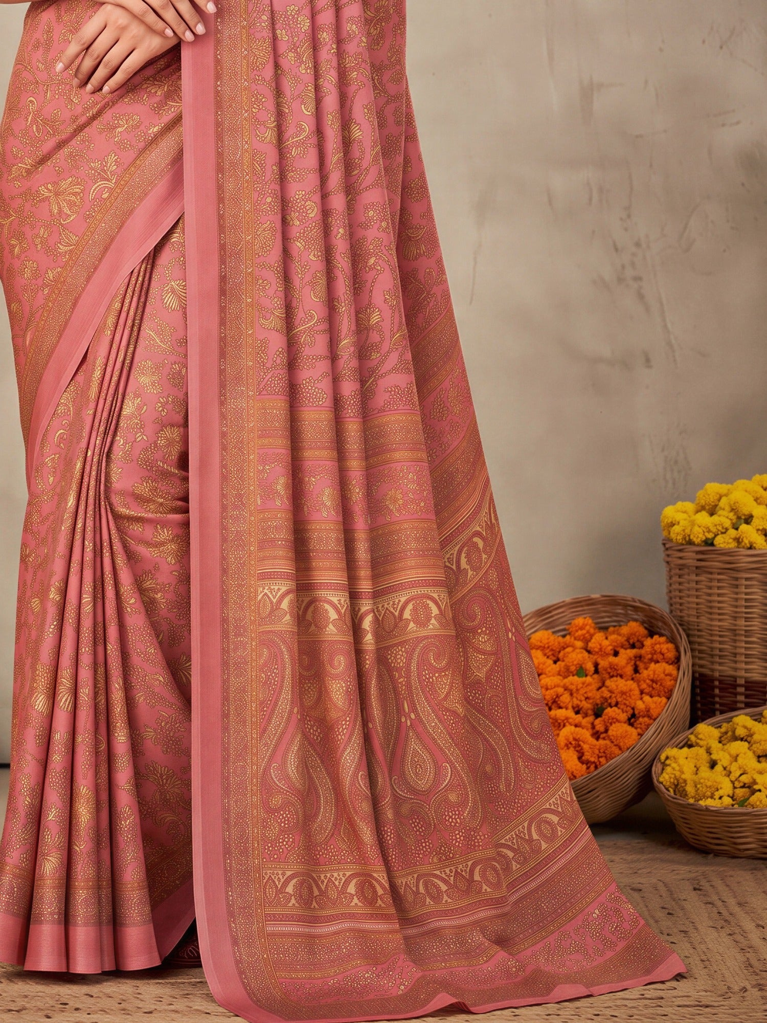 Pallu detail of peach crepe saree showing traditional indian motif work and printed border