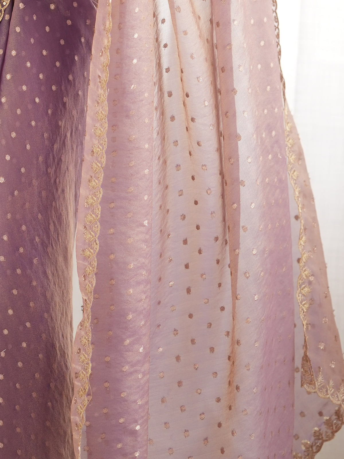Pallu detail of lavender georgette saree showing zari butta (metallic motif) work and embellished border