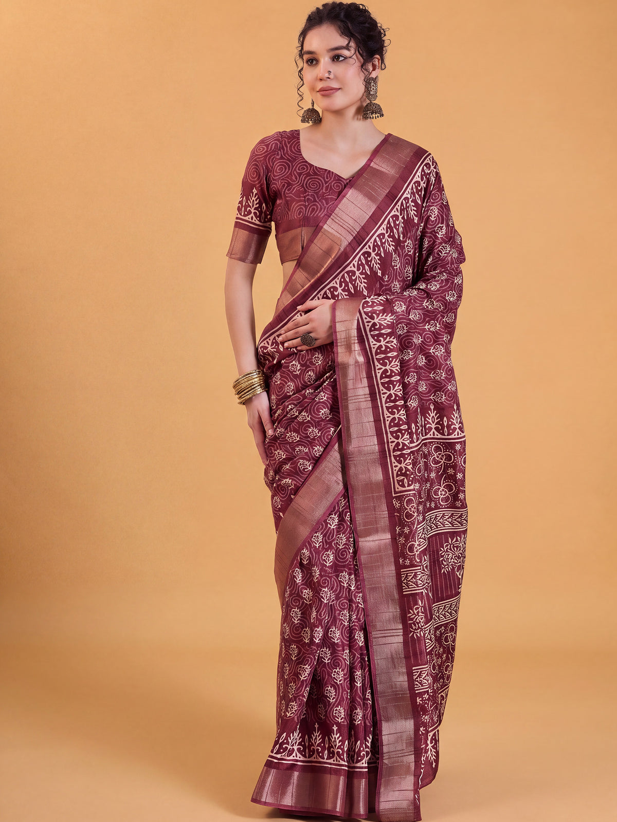 Woman wearing maroon silk blend saree with dabu mud-resist print work and maroon blouse