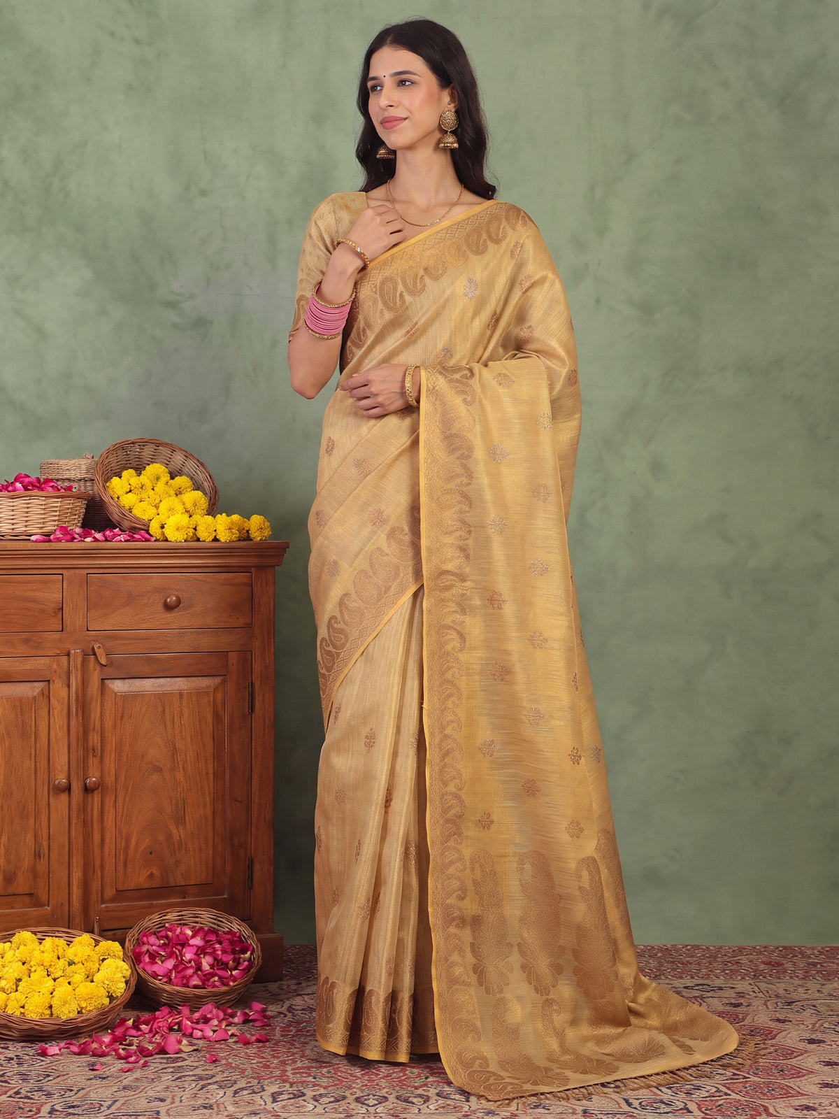 Woman wearing cream linen saree with traditional indian motif work and cream blouse