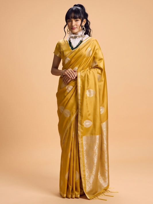 Woman wearing mustard satin silk saree with zari butta (metallic motif) work and mustard blouse