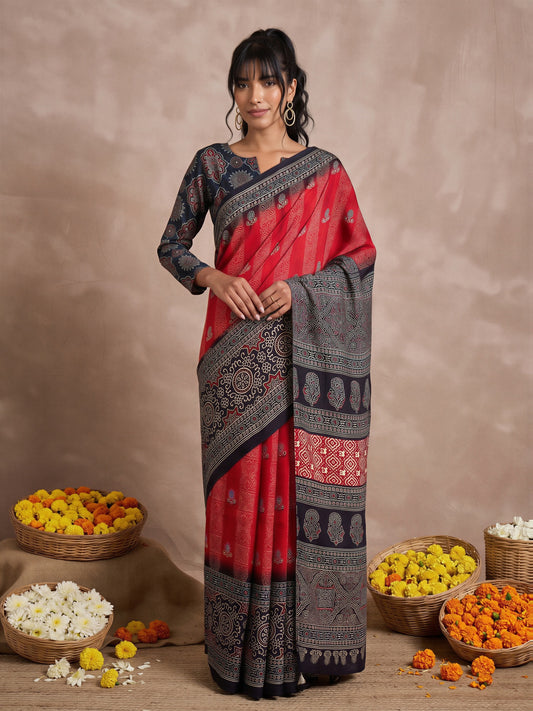 Woman wearing red viscose silk saree with ajrak block-print motif work and navy blue blouse