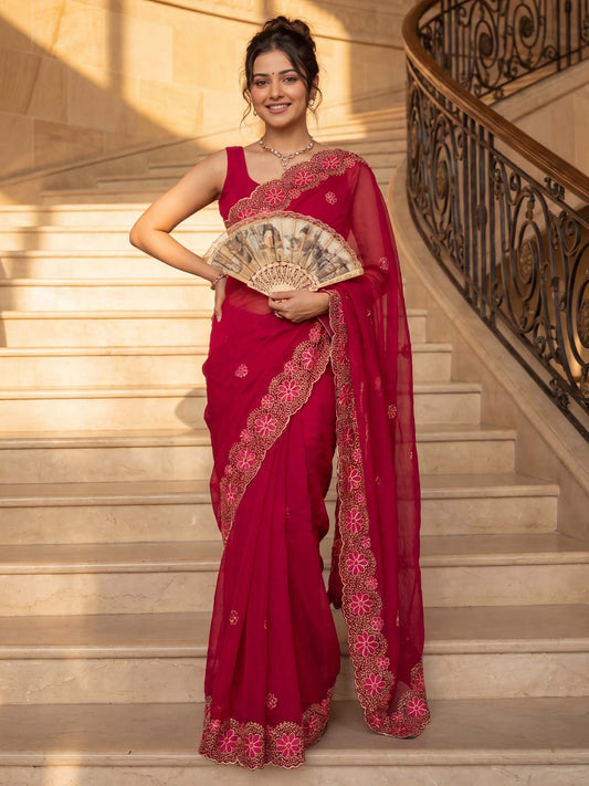 Woman wearing red chiffon saree with embroidered motif work and red blouse