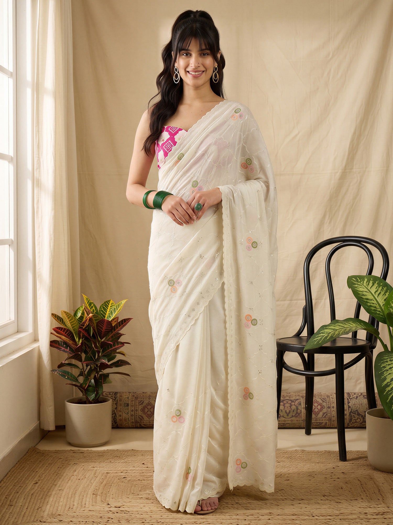 Woman wearing off white vichitra silk saree with ornamented surface design and pink blouse