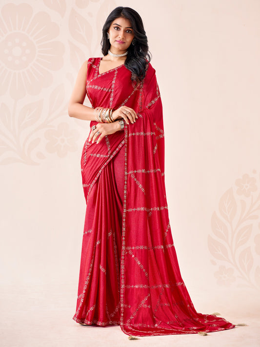 Woman wearing red chiffon saree with ornamented surface design and red blouse