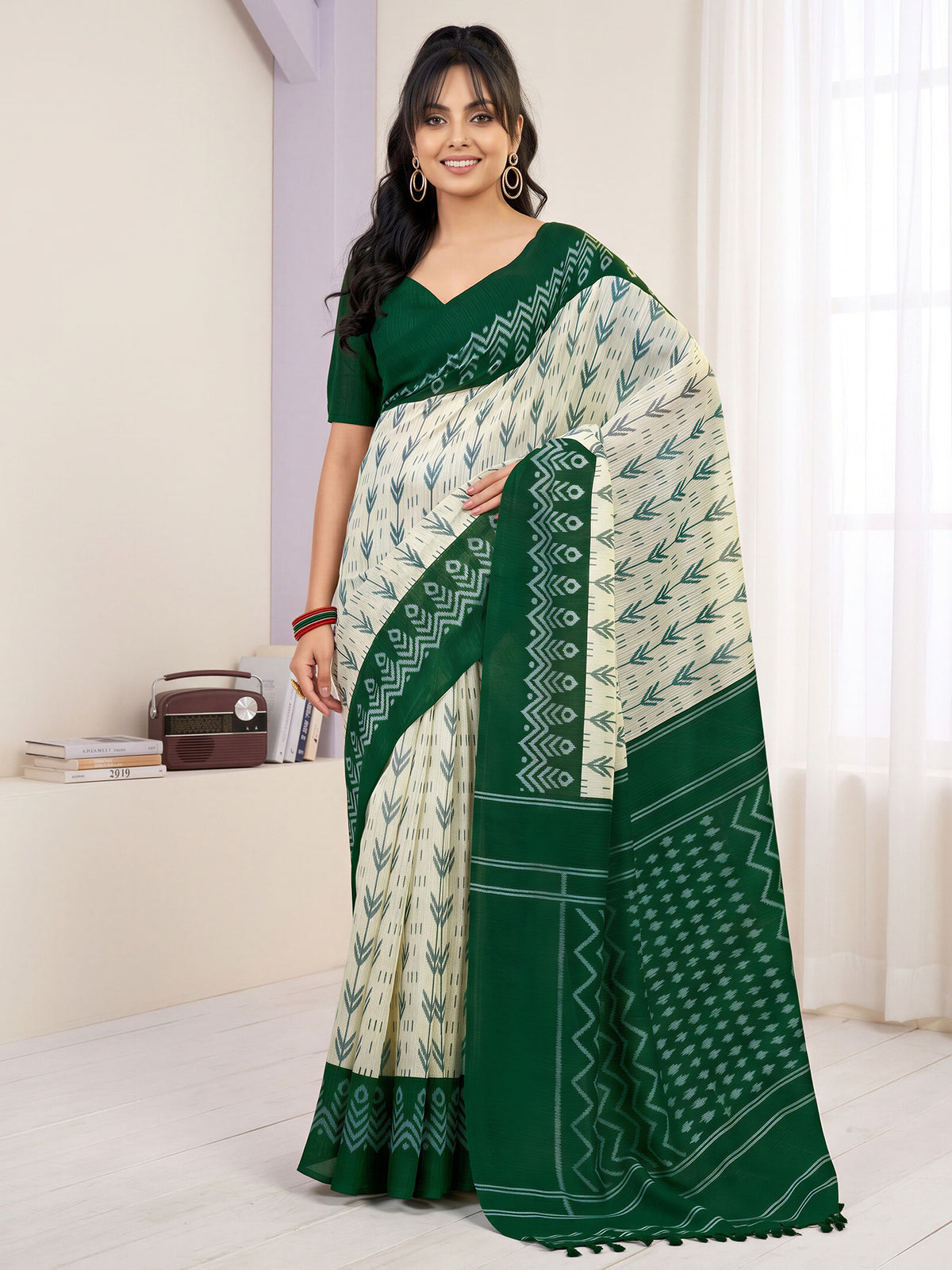 Woman wearing off white cotton blend saree with traditional indian motif work and green blouse