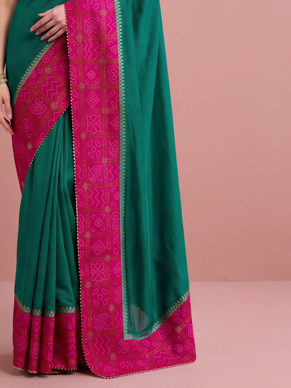 Pallu detail of teal green vichitra silk saree showing bandhani tie-dye dot work and embellished border