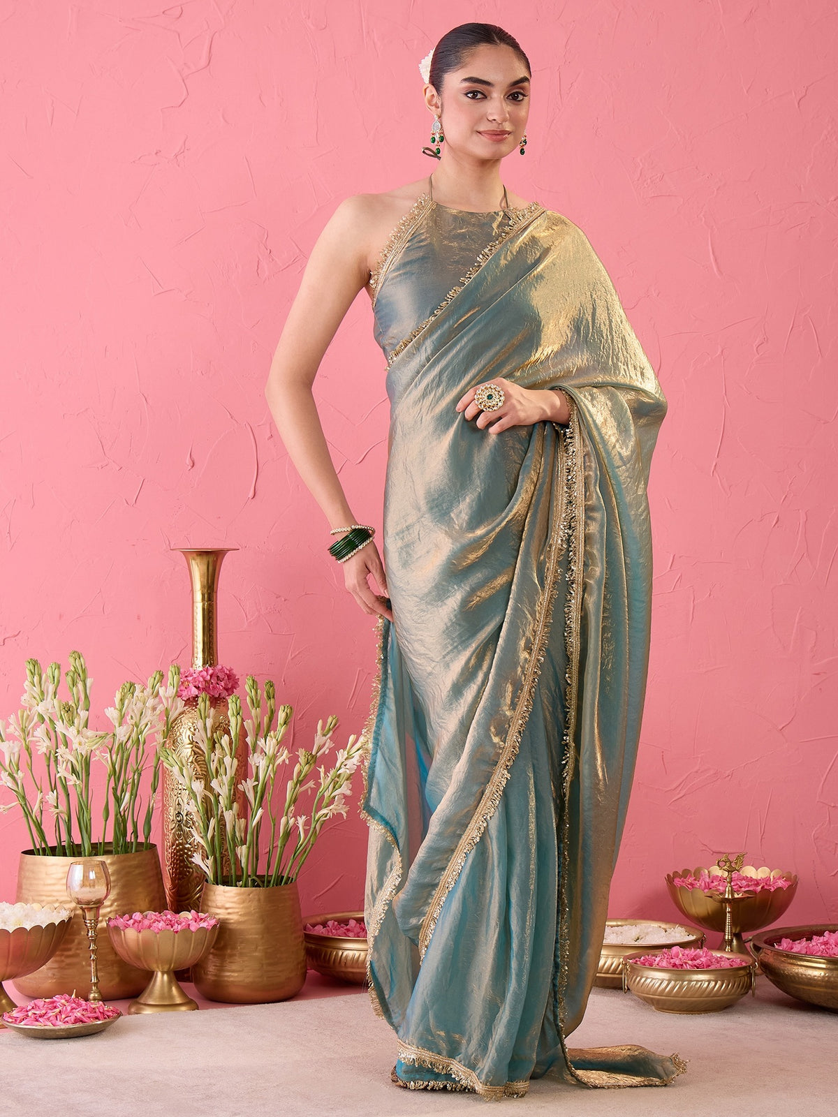 Woman wearing teal blue paper silk ready to wear saree with ornamented surface design and teal blue blouse