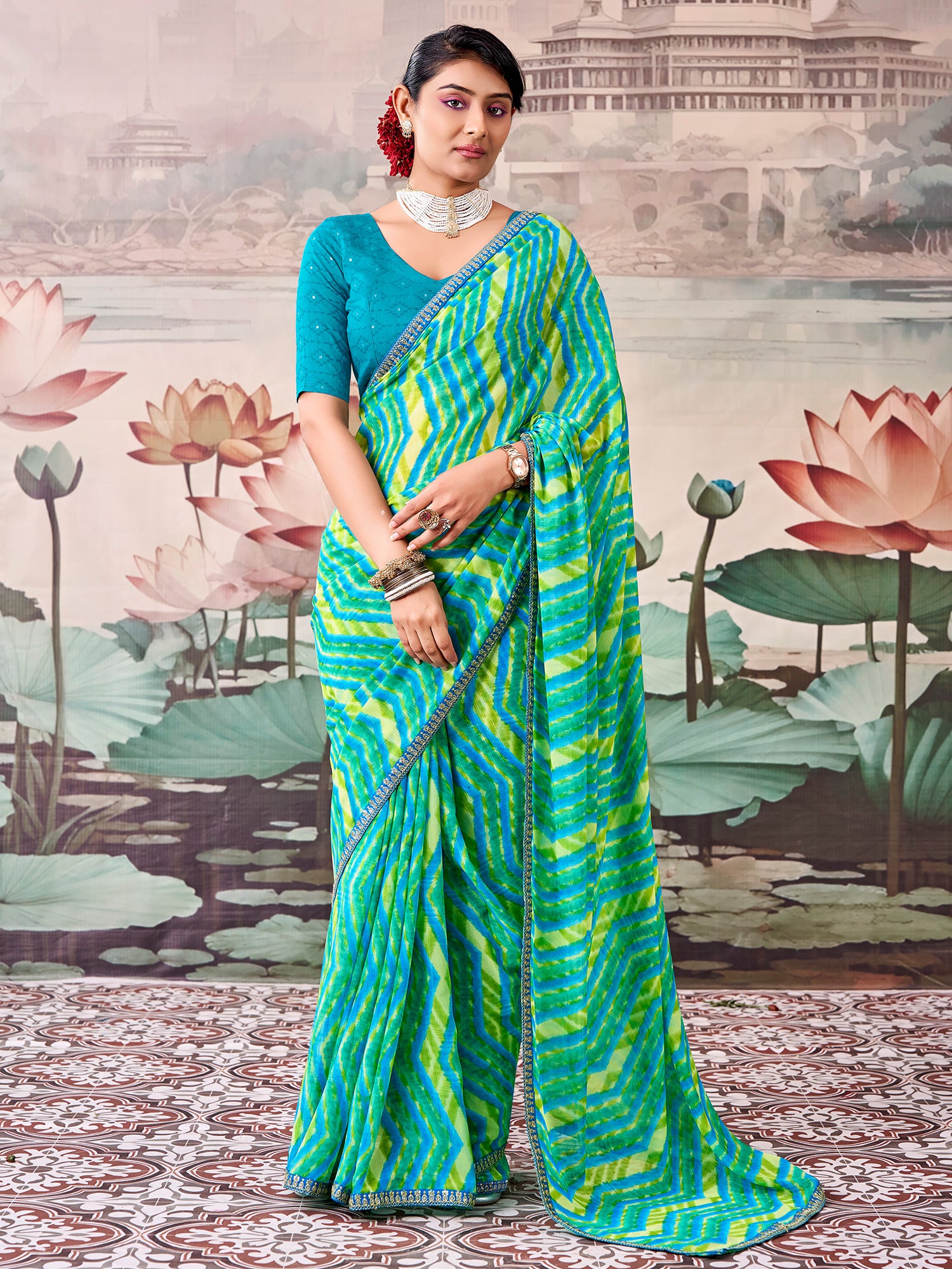 Woman wearing multicolored georgette saree with leheriya design and teal blue blouse