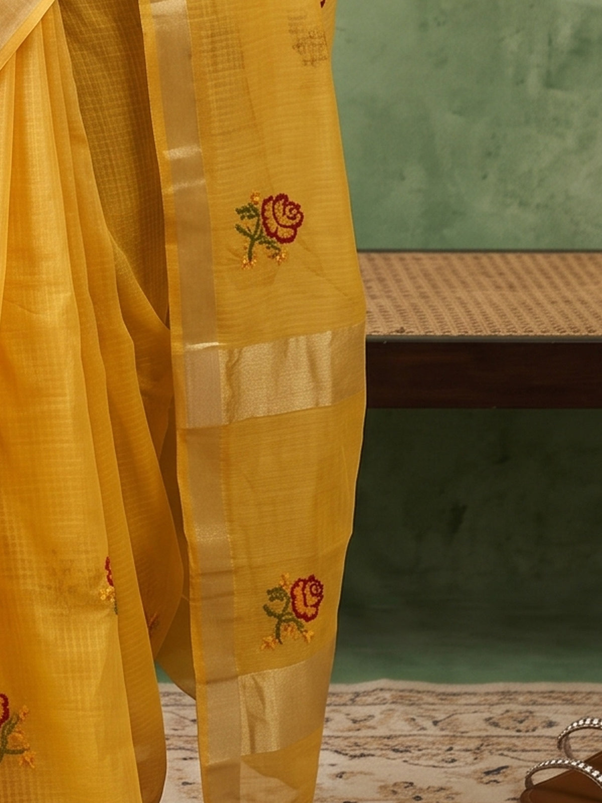 Pallu detail of yellow kota doria cotton saree showing embroidered motif work and zari border
