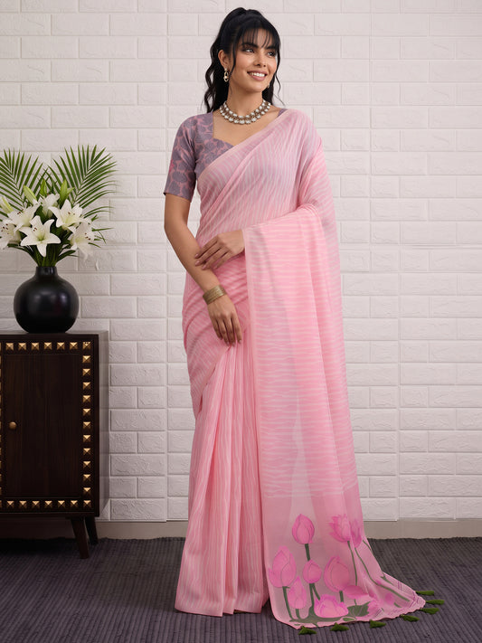 Woman wearing pink viscose saree with traditional indian motif work and mauve blouse