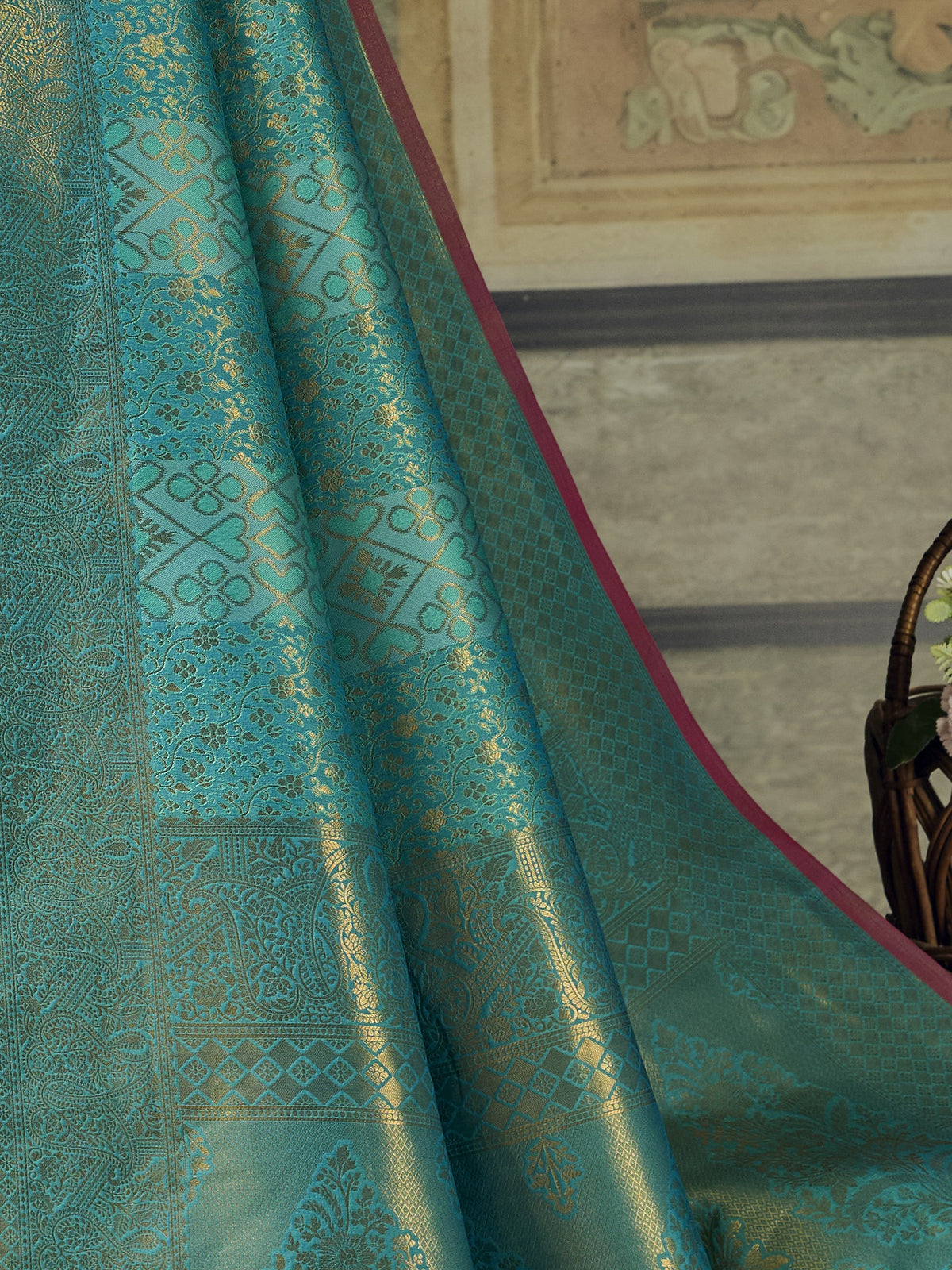 Pallu detail of turquoise blue pure silk saree showing woven motif design and zari border