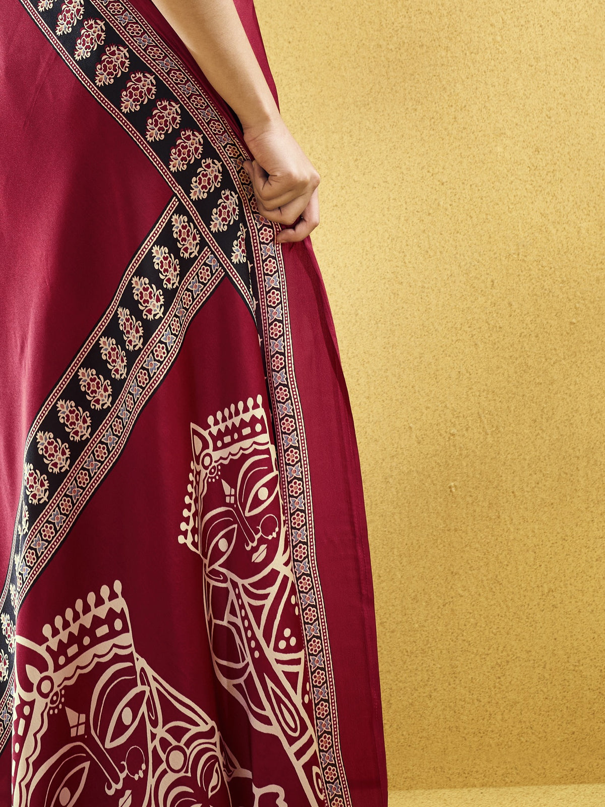 Pallu detail of maroon satin saree showing ajrak block-print motif work and printed border