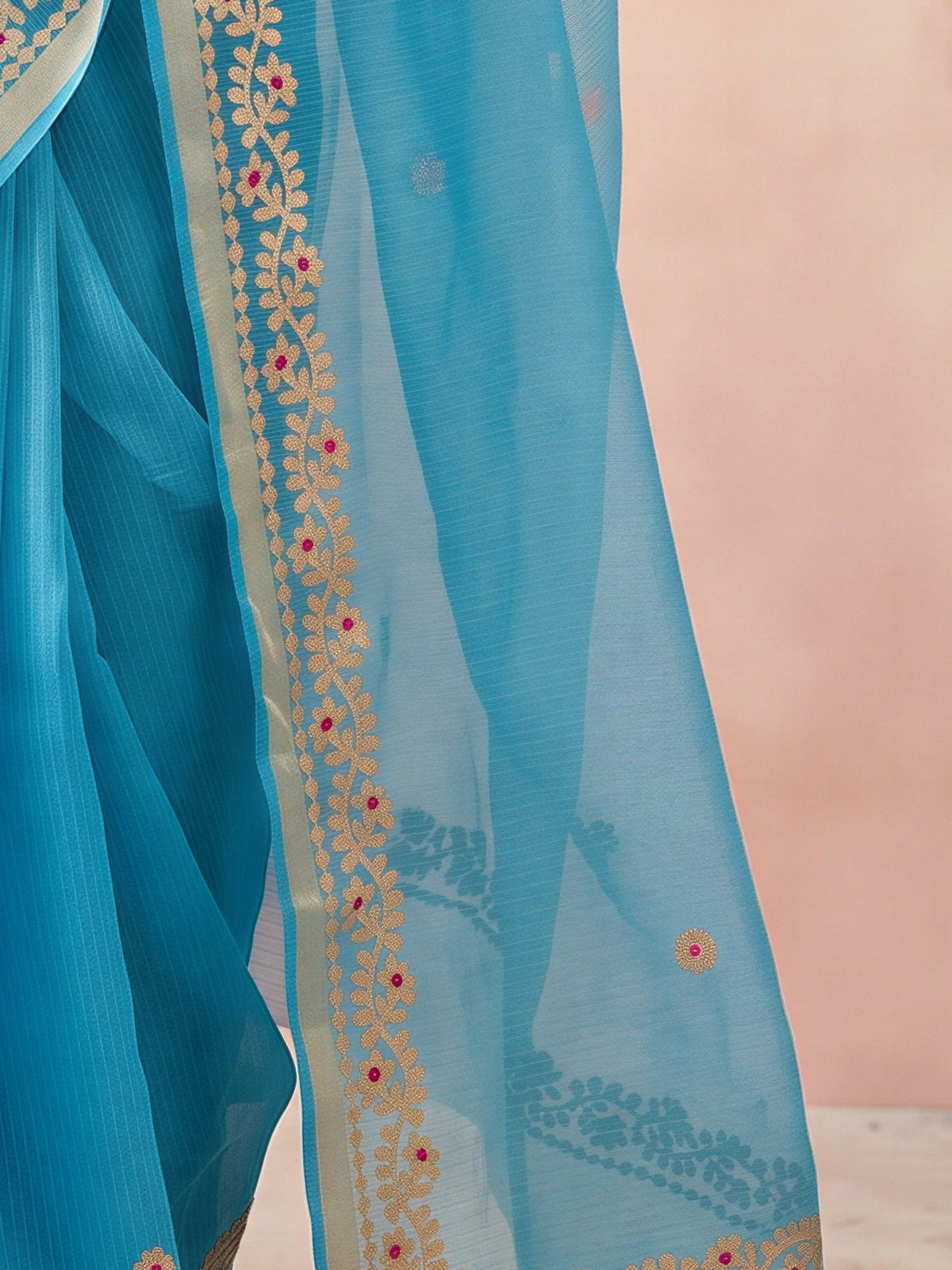Pallu detail of turquoise blue kota doria cotton saree showing ornamented surface design and zari border