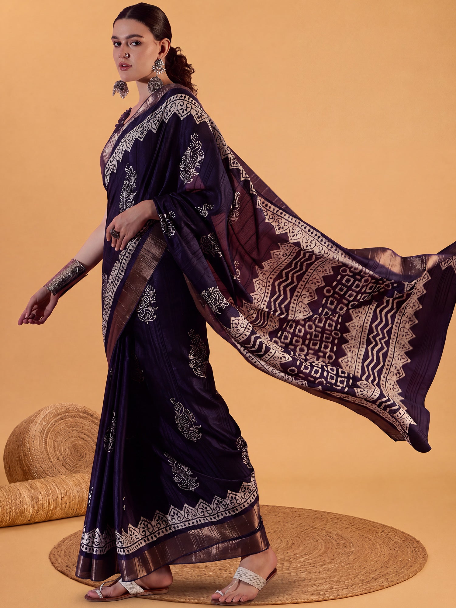 Woman wearing purple silk blend saree with dabu mud-resist print work and purple blouse