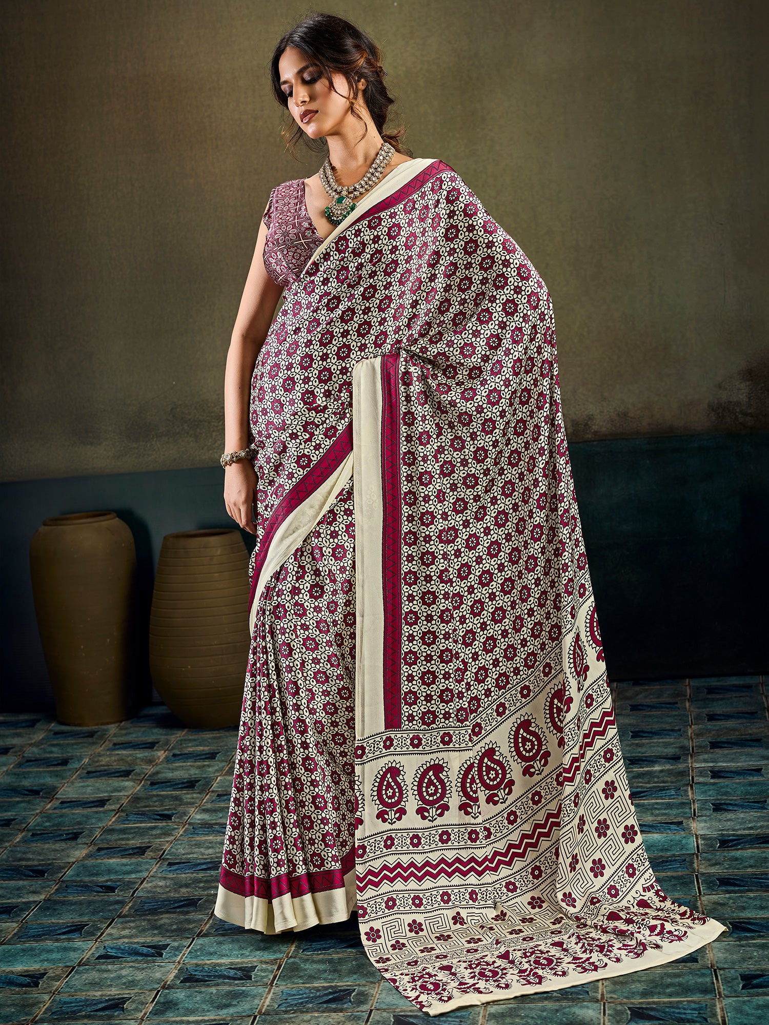 Woman wearing cream satin saree with ajrak block-print motif work and maroon blouse