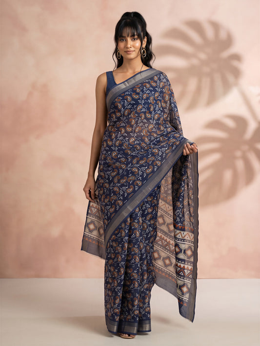 Woman wearing navy blue cotton linen saree with traditional indian motif work and navy blue blouse