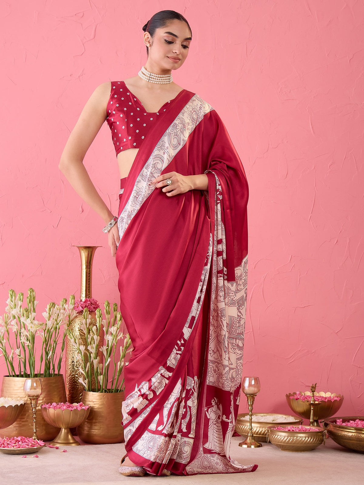 Woman wearing burgundy satin ready to wear saree with kalamkari narrative motif work and burgundy blouse