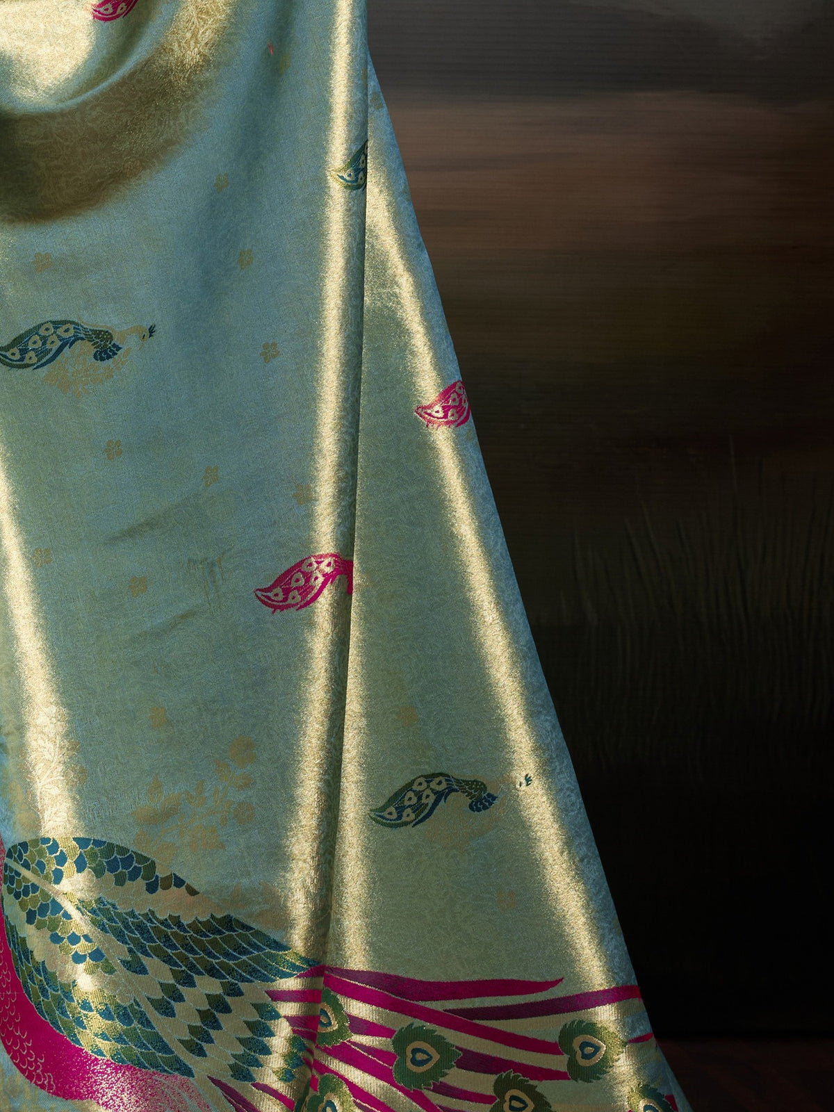 Pallu detail of teal green banarasi silk saree showing woven motif design and zari border