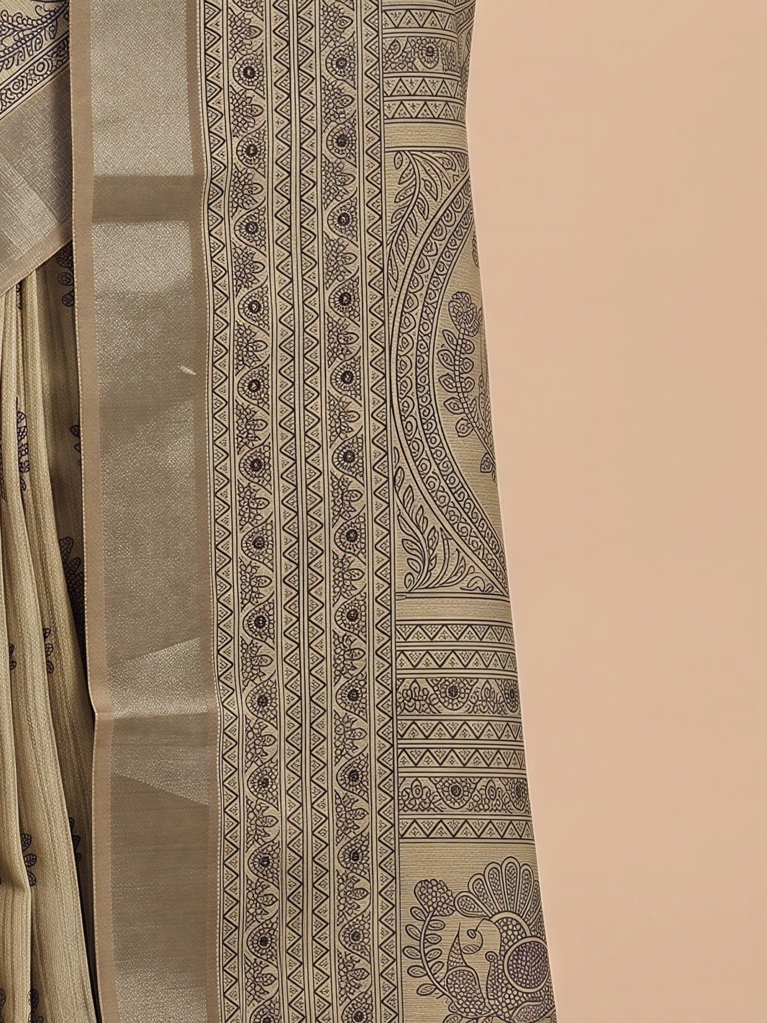 Pallu detail of beige satin silk saree showing hand block-printed motifs and zari border