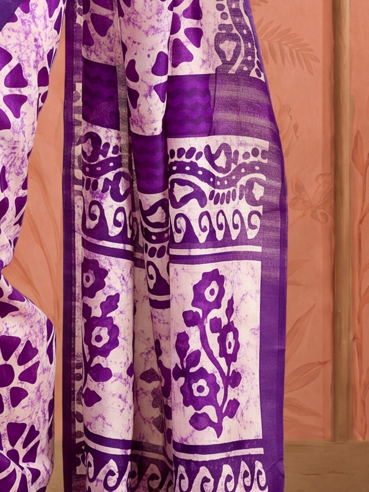 Pallu detail of purple bhagalpuri silk saree showing batik wax-resist design and printed border