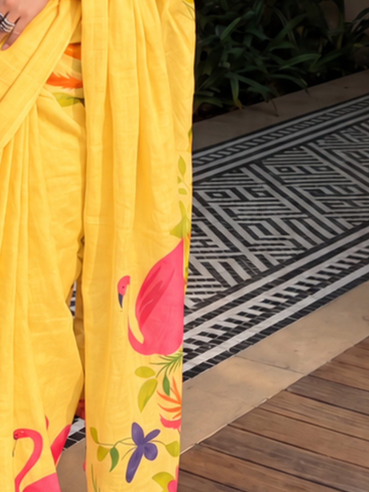 Pallu detail of pink linen saree showing all-over floral design and printed border