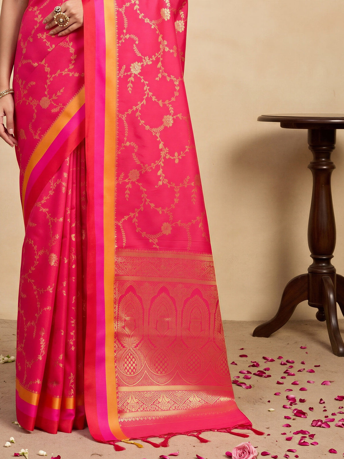 Pallu detail of pink pure silk saree showing traditional indian motif work and zari border