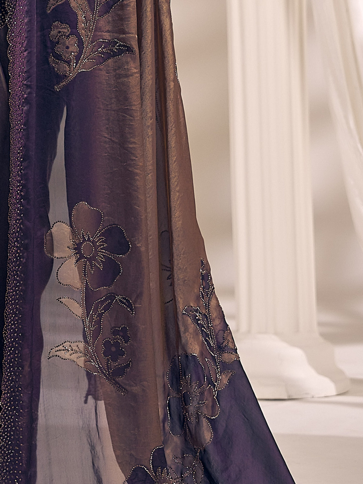 Pallu detail of purple satin silk saree showing ornamented surface design and scallop border
