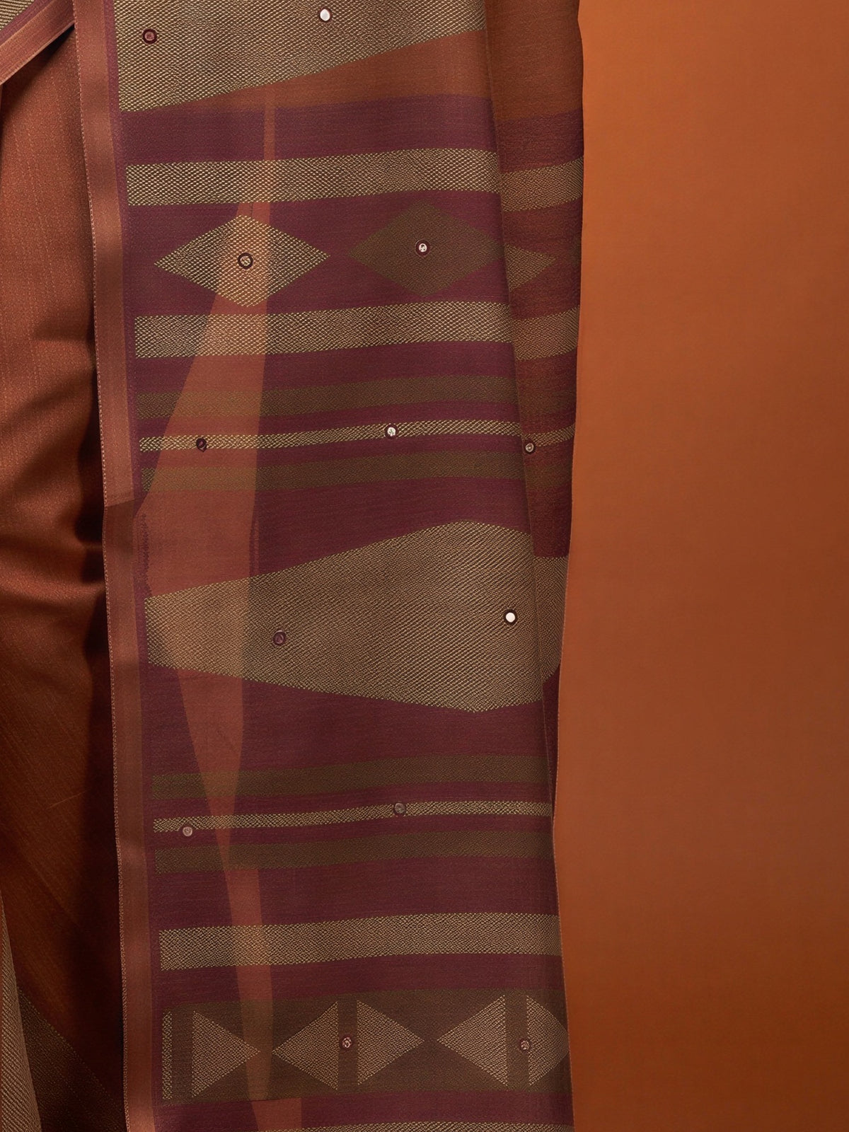 Pallu detail of brown linen blend saree showing geometric pattern design and printed border