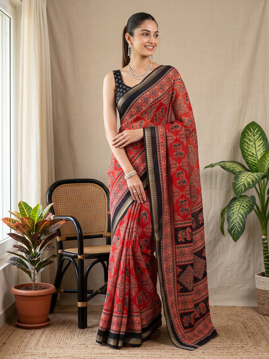 Woman wearing rust georgette saree with traditional indian motif work and black blouse
