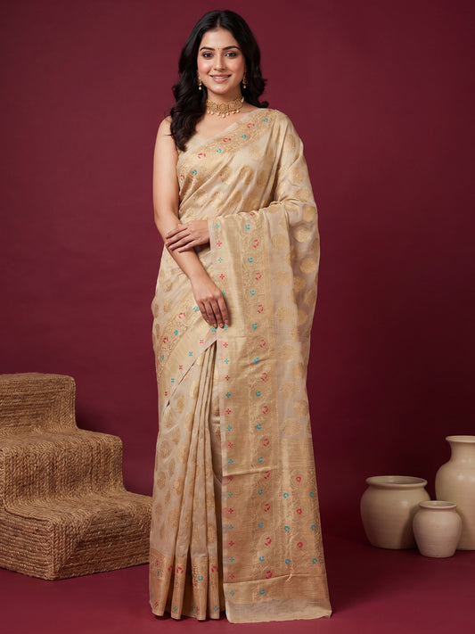 Woman wearing cream silk blend saree with zari butta (metallic motif) work and cream blouse