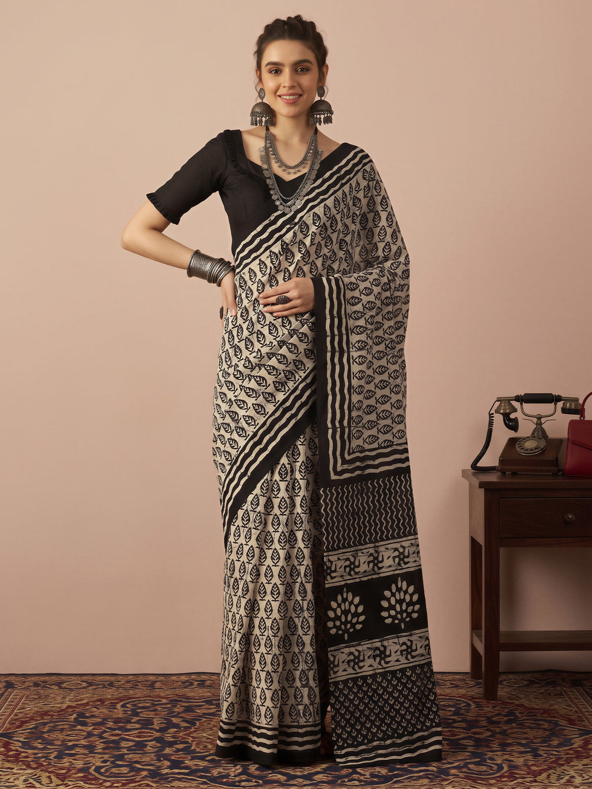 Woman wearing beige bhagalpuri silk saree with batik wax-resist design and black blouse