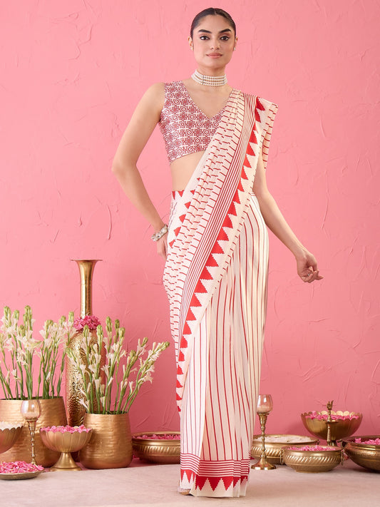 Woman wearing cream satin ready to wear saree with striped pattern design and cream blouse