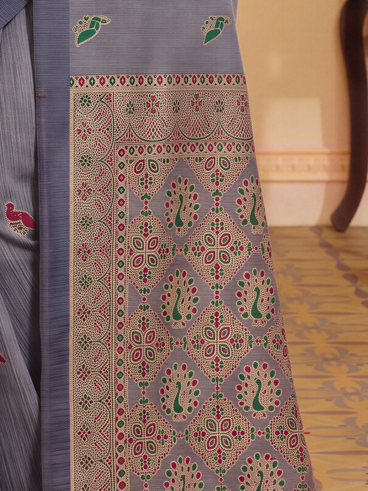 Pallu detail of grey melange silk blend saree showing woven motif design and woven design border
