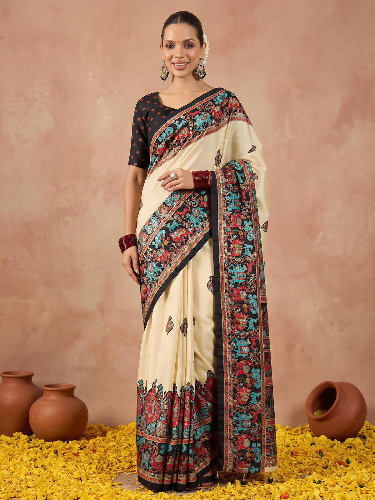 Woman wearing black silk blend saree with metallic foil print work and black blouse
